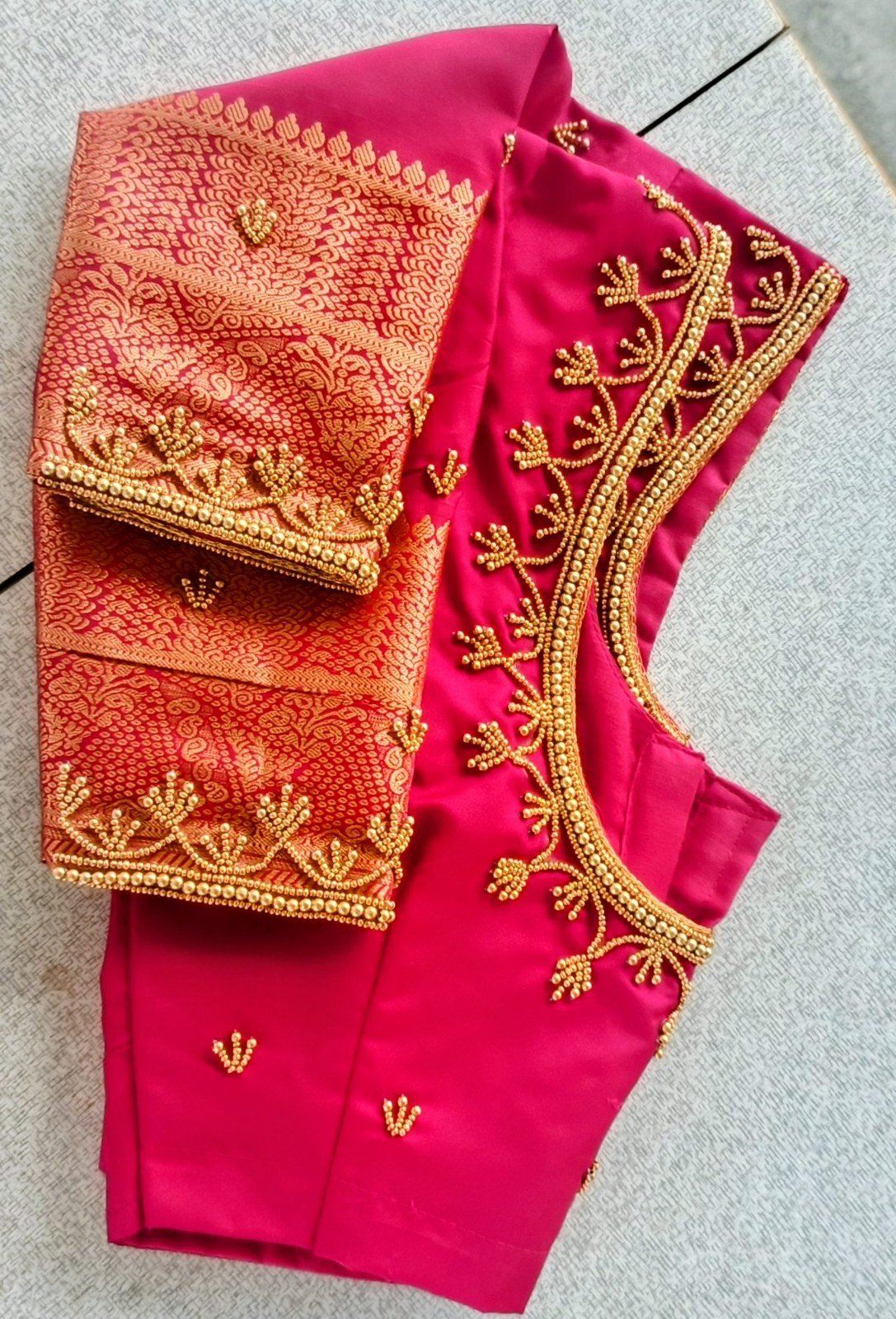 Intricate peacock and mango motif aari embroidery on blouse sleeve