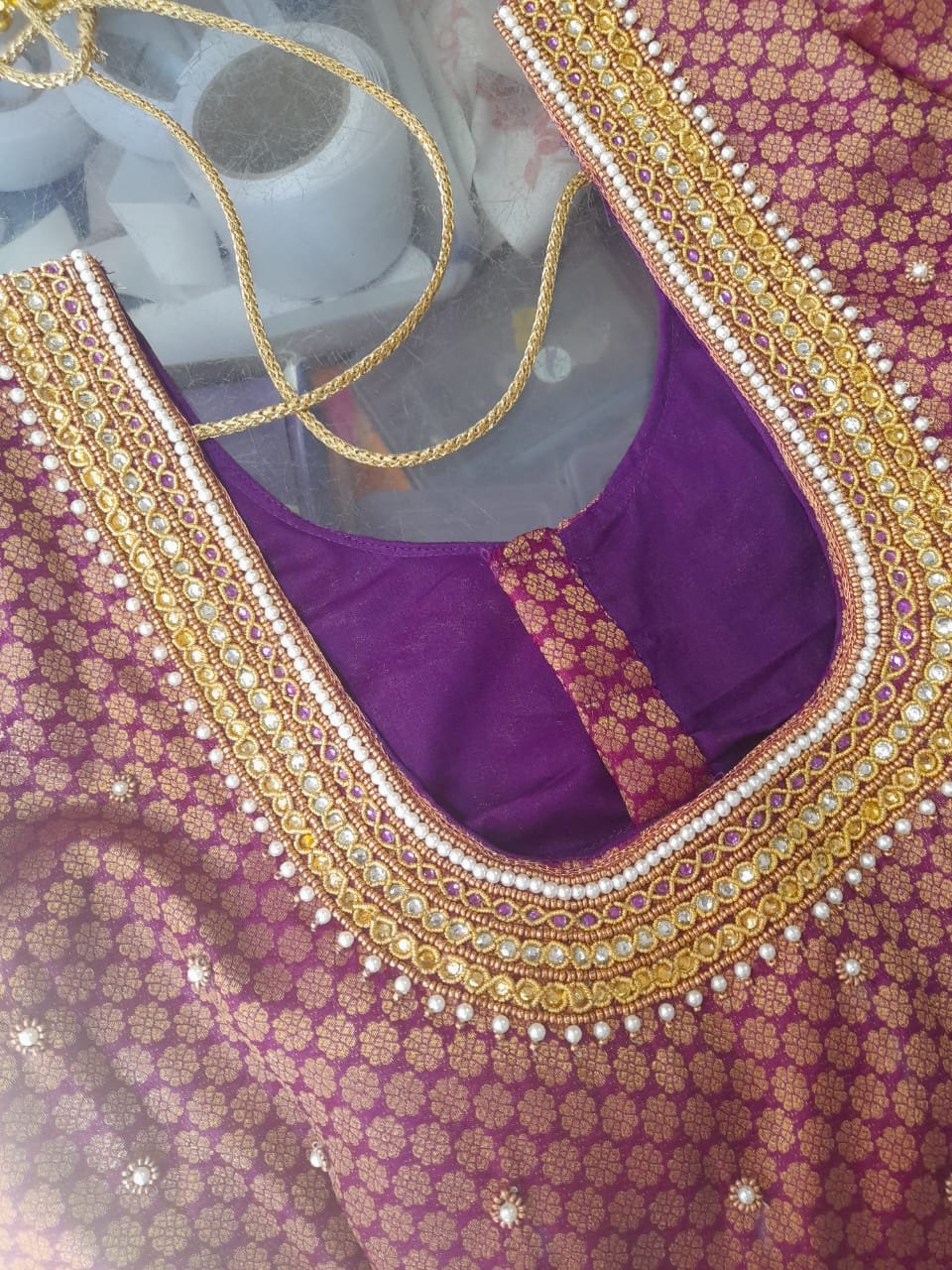Dark purple bridal blouse neckline design with grand maggam embroidery